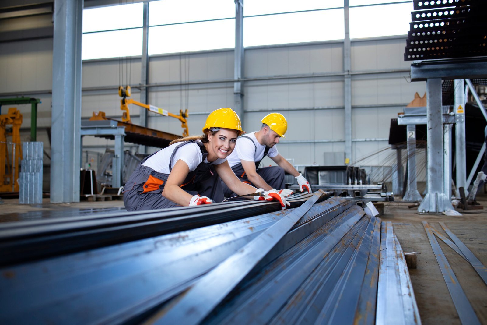 industrial workers working factory hall with metal scaled.jpg